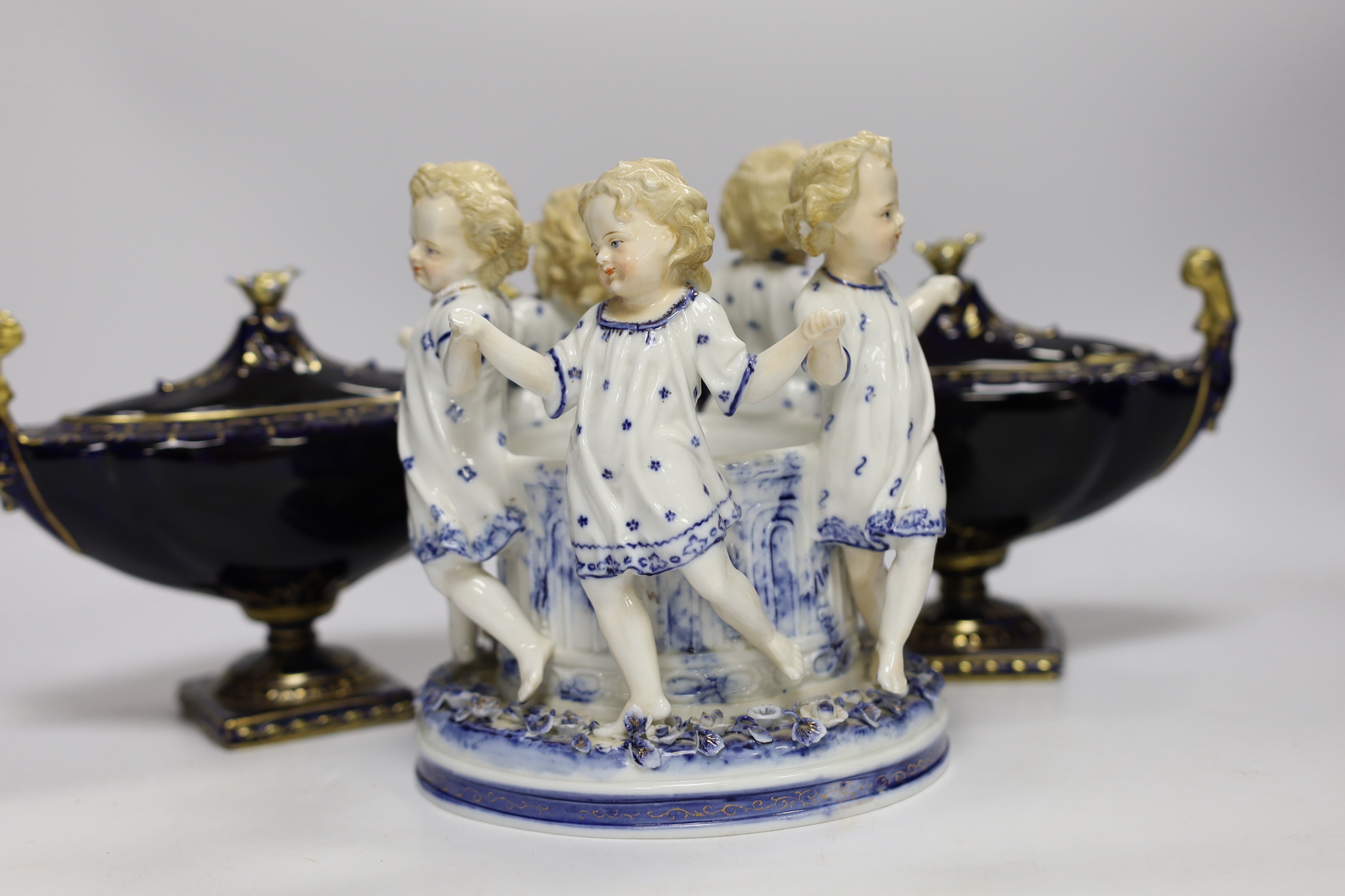 A Volkstedt porcelain figure group of children dancing together with two urns and covers (3), figure group 8cm